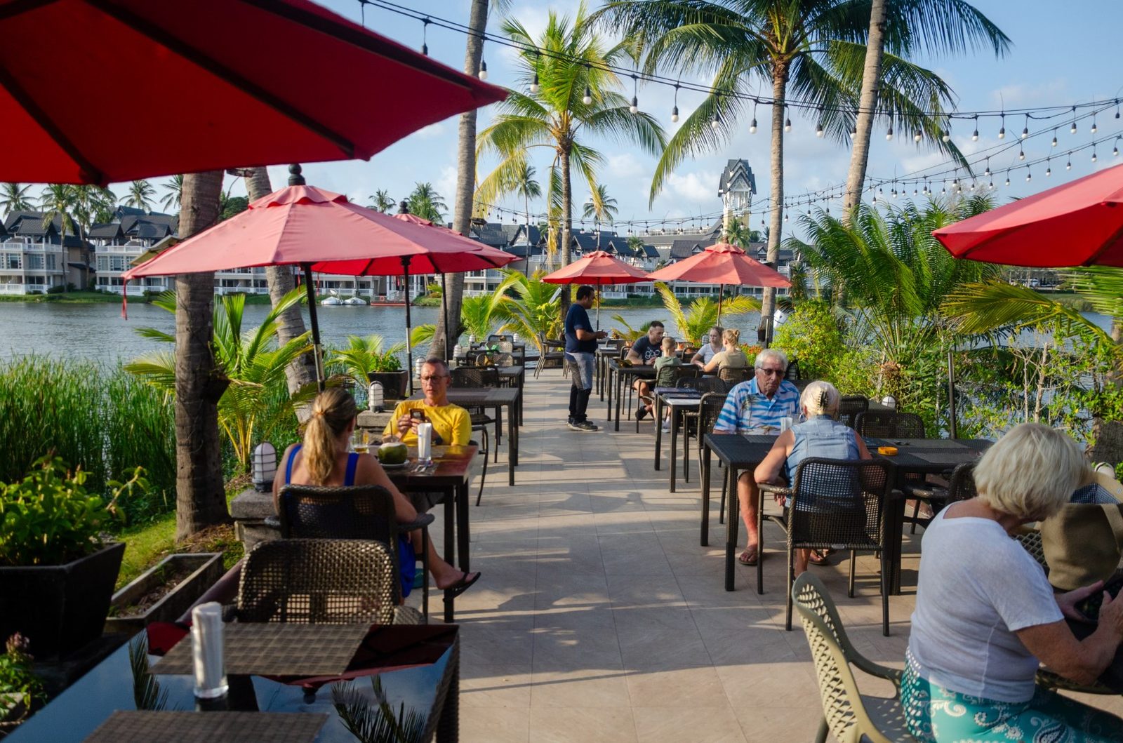 Guests dining on the lakeside terrace of Albatross Café